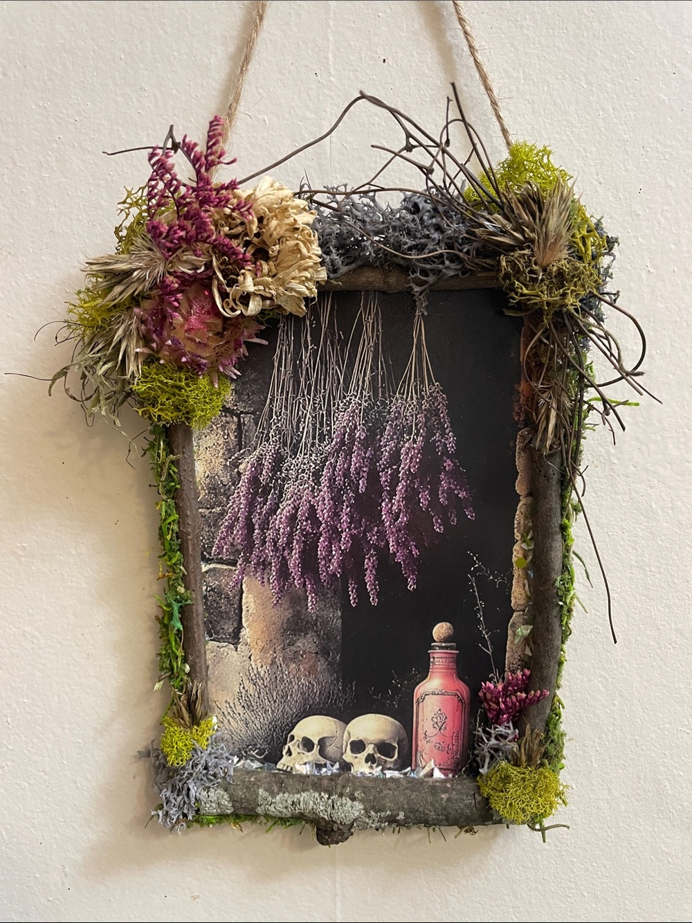 Handcrafted border on a postcard skulls potion bottle dried florals moss gothic